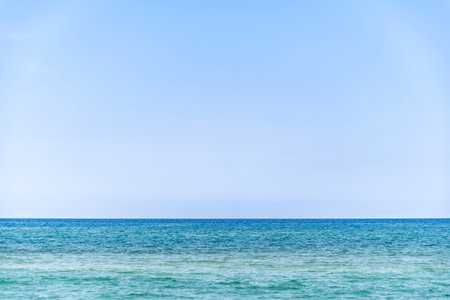 Scenic Mediterranean sea during summer with ample copy space against a serene light blue sky....