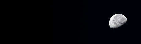 Half moon against a black background, providing ample copy space. Its large panoramic view makes it...