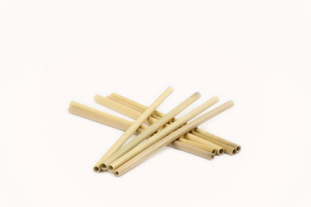 Eco-friendly bamboo drinking straws, a sustainable alternative to plastic, showcased against a clean white background. 'no to plastic' concept, offering copy space for your messageの写真素材