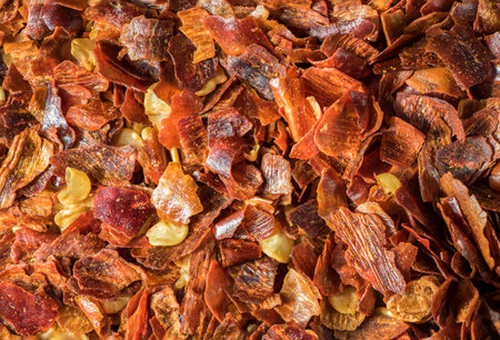 close-up of crushed dried chili pepper showing the fiery intensity and vibrant color of this popular spiceの写真素材