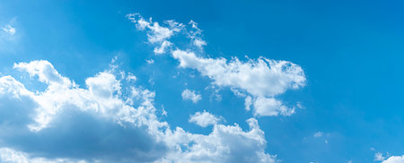 Panoramic of white clouds against blue sky, perfect background for website, banner and othersの写真素材