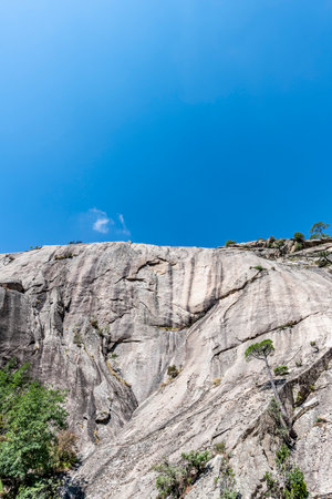 Clear Blue Sky with few white clouds and cliff for background or presentation with large copy spaceの写真素材