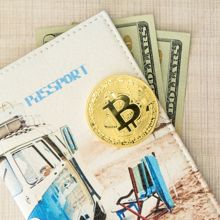 Bitcoin golden coin with passport cover and dollars money. Copy spase for text on the wooden background, Square picture.の写真素材