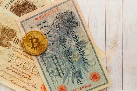 Bitcoin with old german money. Inflation 1923, one million marks. Cryptocurrency concept background....