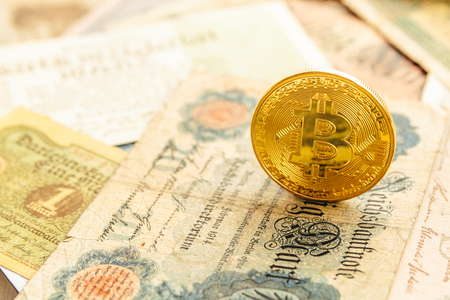 Bitcoin with old german money. Inflation 1923, one million marks. Cryptocurrency concept background. Closeup, copy space.の写真素材