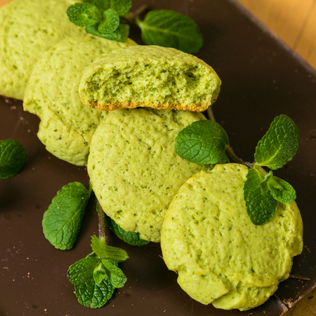 Peppermint Cookies with mint leaves stacked on dark chocolate bar. Square pictureの写真素材