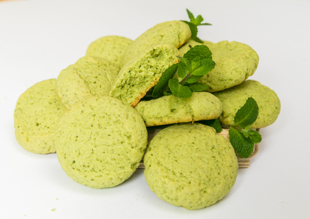 Peppermint Cookies with fresh mint leaves, the closeup on white backgroundの写真素材