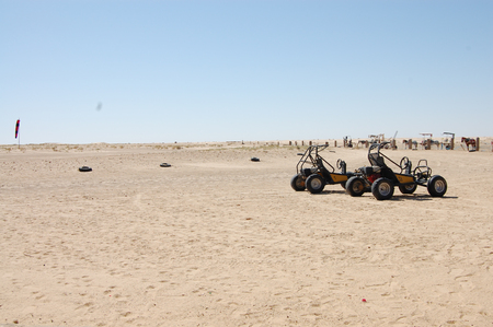 a desert car stands on the sand in the afternoonの写真素材