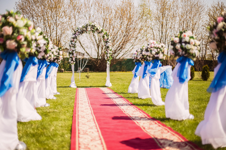 wedding ceremony in the open air in the park and red carpetの写真素材
