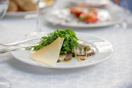 salad on  plate in a restaurant on a tableの写真素材