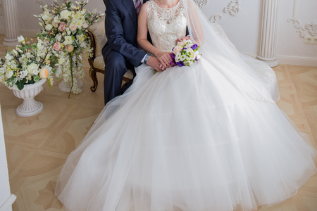 bride and groom sit  the couchの写真素材