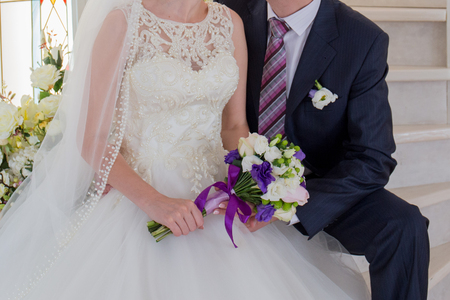 bride and groom sit on  stairsの写真素材