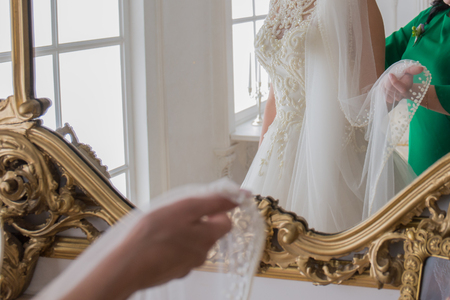 bride buttoned wedding dress on  backの写真素材