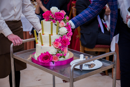 wedding cake takes the waiter in a restaurantの写真素材