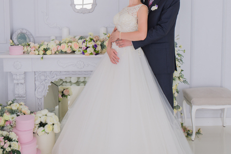 bride and groom stand together in a bright roomの写真素材