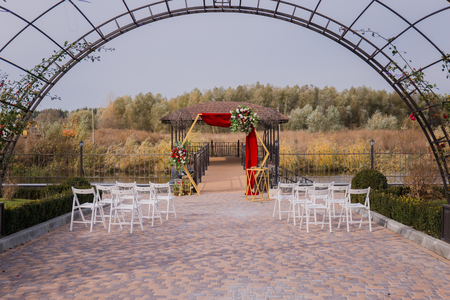 arch and chairs for a wedding ceremony in the parkの写真素材
