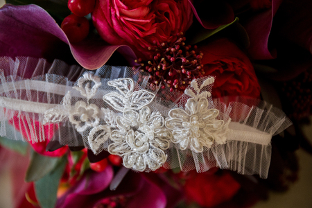 the garter of the bride lies on a wedding bouquetの写真素材