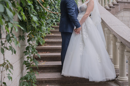 bride and groom together on the stairsの写真素材