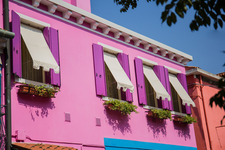 colored houses on the street in the city of buranoの写真素材
