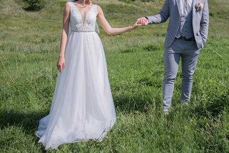 bride and groom in a green fieldの写真素材