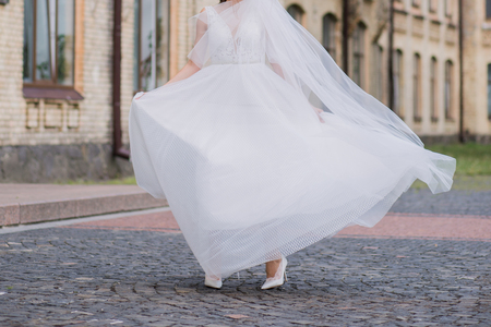 bride with veil and wedding dress in the squareの写真素材