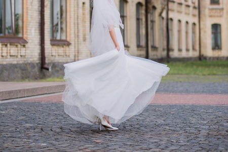 bride with veil and wedding dress in the squareの写真素材