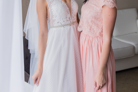 bride with girlfriend in a pink dressの写真素材