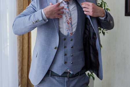 the man in the room puts on a suitの写真素材