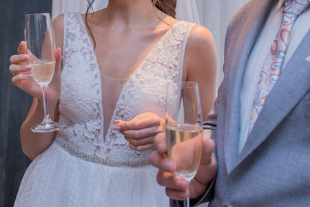 bride and groom hold glasses of champagneの写真素材