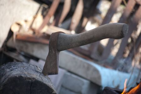 bonfire in an iron brazier with firewood and ax