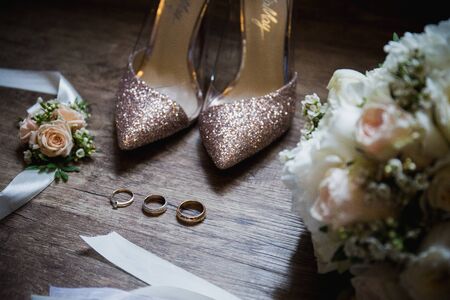 wedding rings near the shoes the brideの写真素材