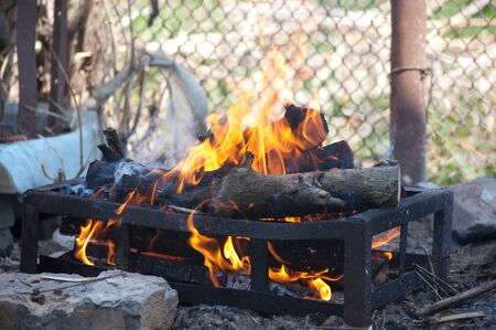 bonfire in iron barbecue grill picnic burnsの写真素材
