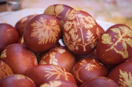 Easter eggs with leaf patterns on tableの写真素材