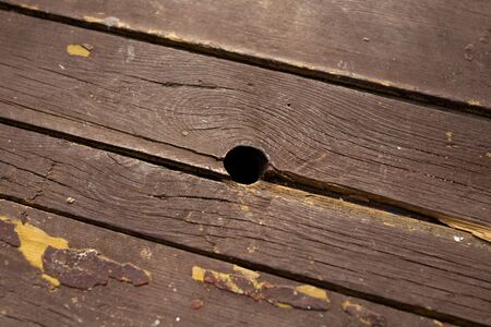 very old wooden floor with holes slivers