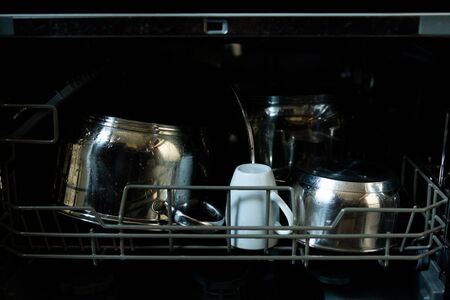 inside the dishwasher pans with cups are dirtyの写真素材
