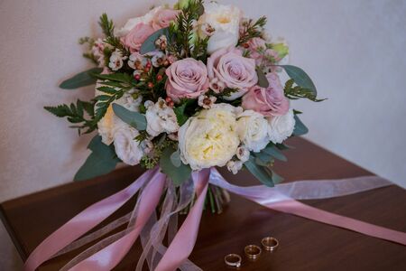 wedding gold rings with bouquet of the brideの写真素材