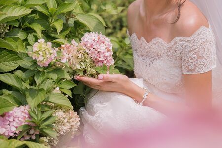 bride with bouquet of flowers in the parkの写真素材