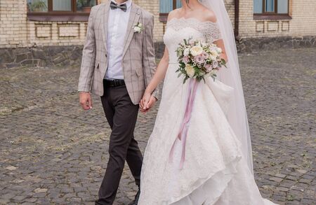 the bride and groom in summer park togetherの写真素材