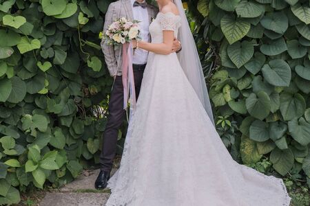the bride and groom in summer park togetherの写真素材