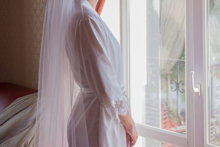bride in peignoir in the morning in roomの写真素材
