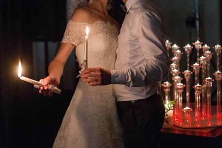 bride and groom light candles at weddingの写真素材