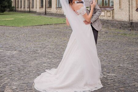 the bride and groom in summer park togetherの写真素材