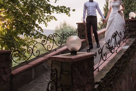 bride and groom in evening at sunsetの写真素材