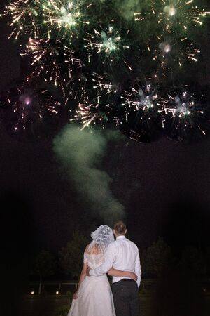 the bride and groom look at the fireworksの写真素材