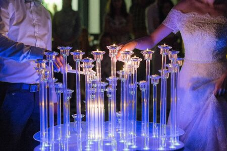 bride and groom light candles at weddingの写真素材