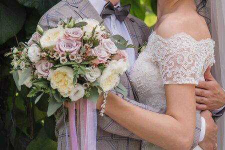 the bride and groom in summer park togetherの写真素材