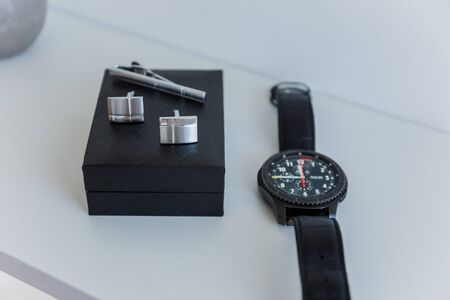 smart watch with cufflinks on the tableの写真素材