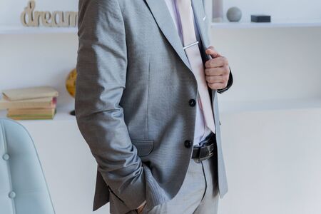 man puts on a gray suit jacketの写真素材