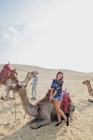 woman near camel in the Sahara desertの写真素材