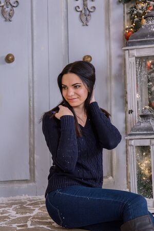 woman sitting on the stairs house for christmasの写真素材